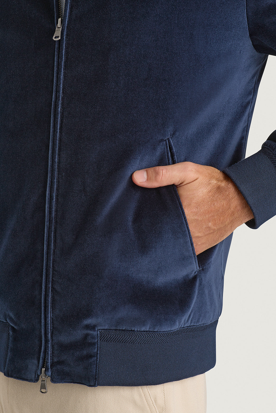 Velvet bomber jacket in navy on hanger